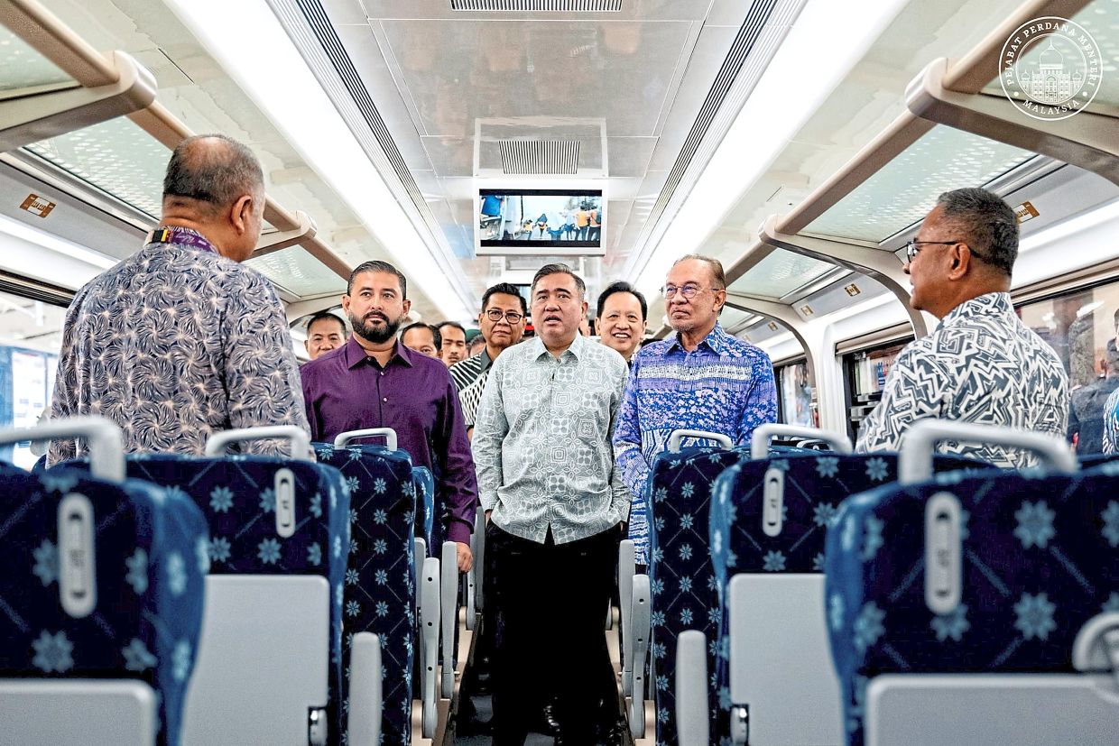 On the right track: (From left, front row) Tunku Ismail, Loke and Anwar attending the launch of the ETS 3 train service at the Kempas Baru station. — Picture from the Prime Minister’s Office