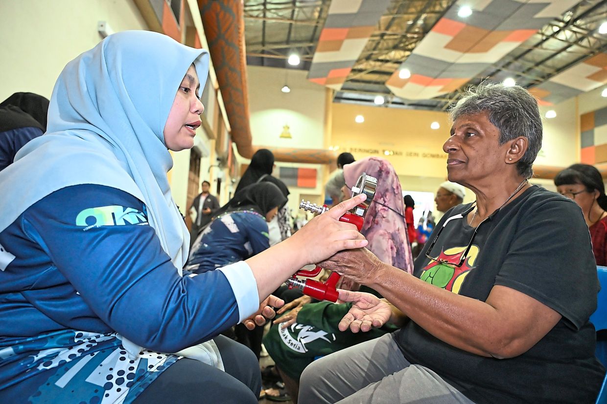 A senior citizen getting her grip strength tested during the Selangor Senior Citizens’ Health Programme 2025 in Selayang on May 31. Reduced grip strength is a sign of frailty. — Photos: Filepic