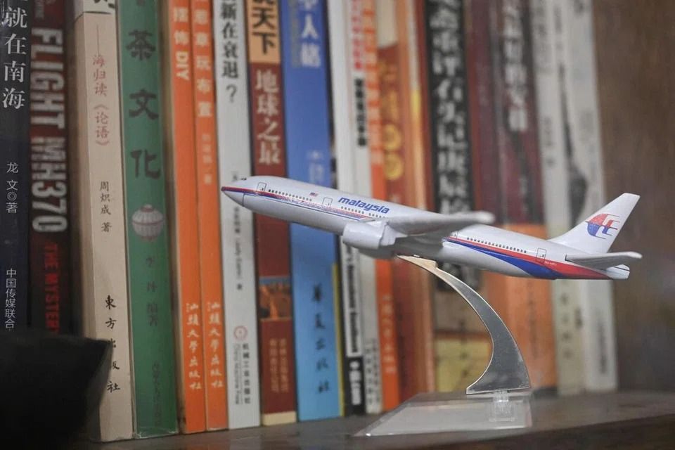 A miniature model of a Malaysia Airlines Boeing 777 aircraft is seen on a shelf in the home of Mr Jiang Hui on Dec 10. - Photo: AFP