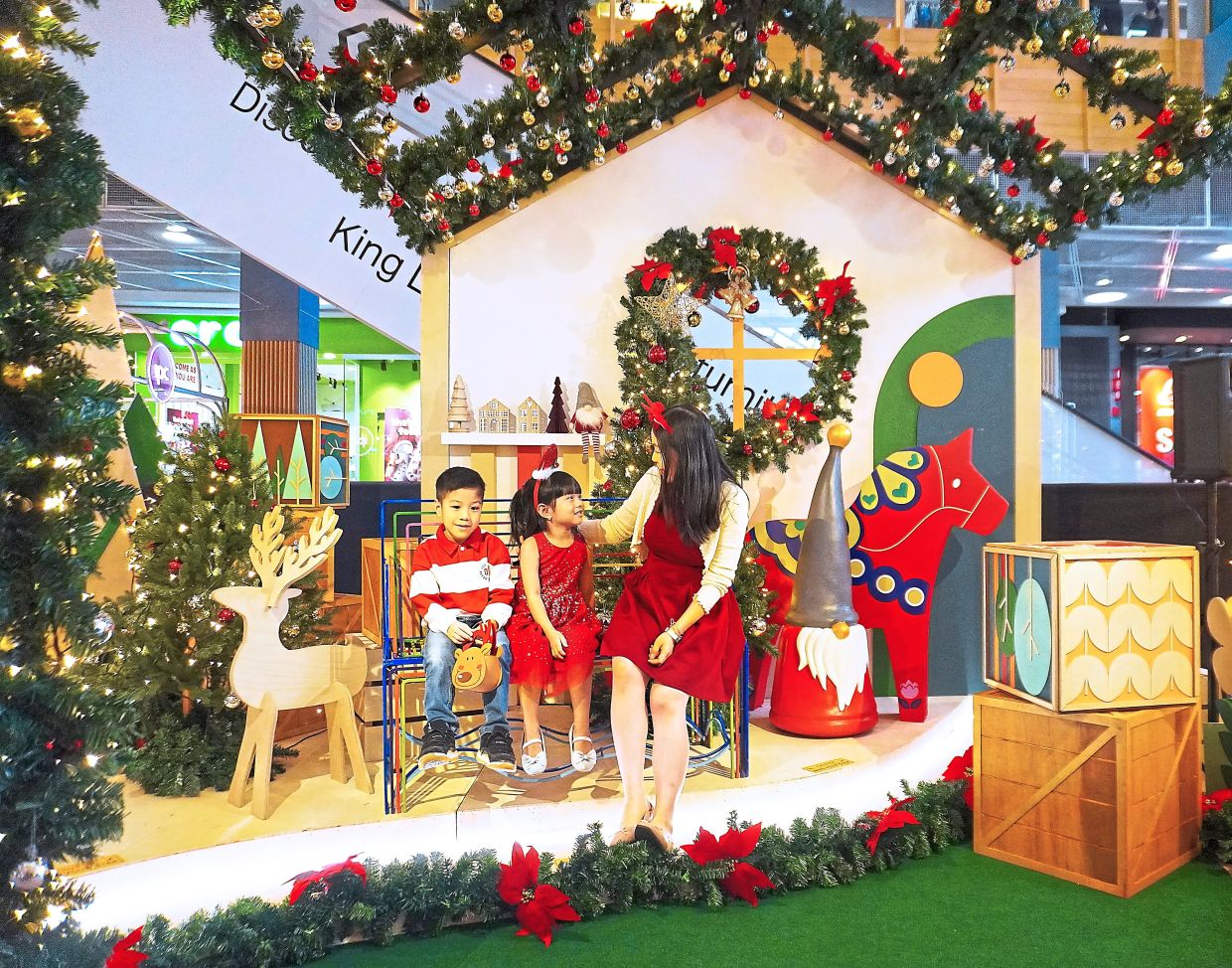 Visitors sitting in front of the Dala Horse at IPC shopping centre. 