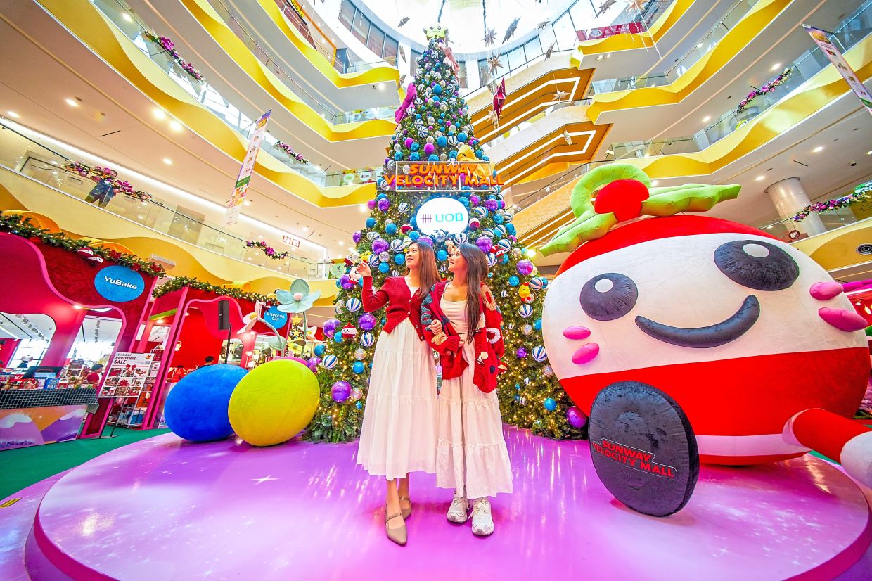 Bubbly and a Christmas tree make a striking background for photos at Sunway Velocity.