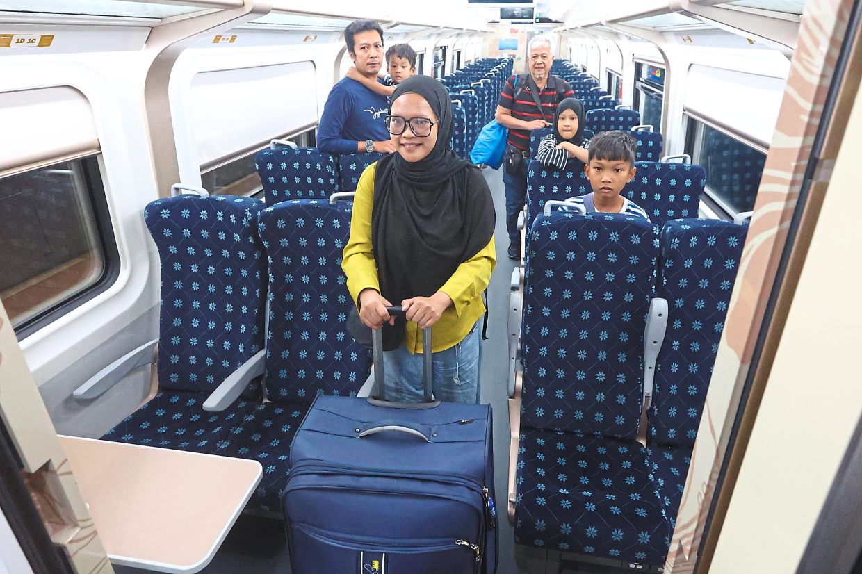 Sulia and her family disembarking at KL Sentral. — FAIHAN GHANI/THOMAS YONG/The Star