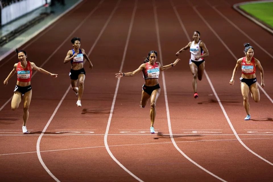 Singapore sprint queen Shanti Pereira sprinting past the finish line in the women?s 200m final at the SEA Games at Suphachalasai National Stadium in Bangkok on Saturday, Dec 13. -- ST PHOTO: BRIAN TEO