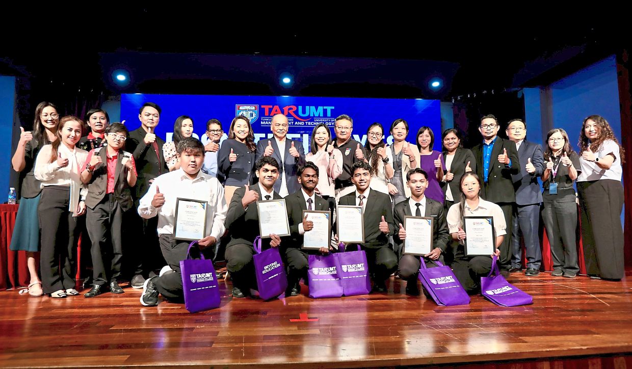 United front: (Eighth and ninth from left) Ong and Tan Sri Chan Kong Choy posing for a group photo with panellists and student representatives.