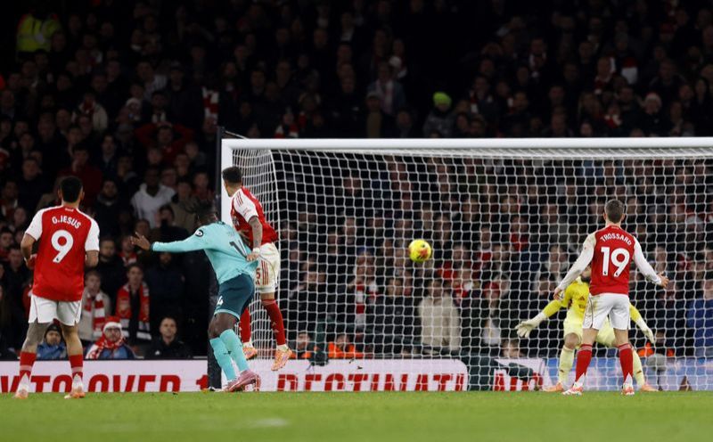 Soccer-Arsenal get lucky break to go five points clear, Salah returns for Liverpool