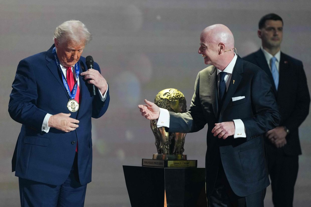 Trump receiving the FIFA Peace Prize from Infantino during the draw for the 2026 FIFA Football World Cup. — AFP