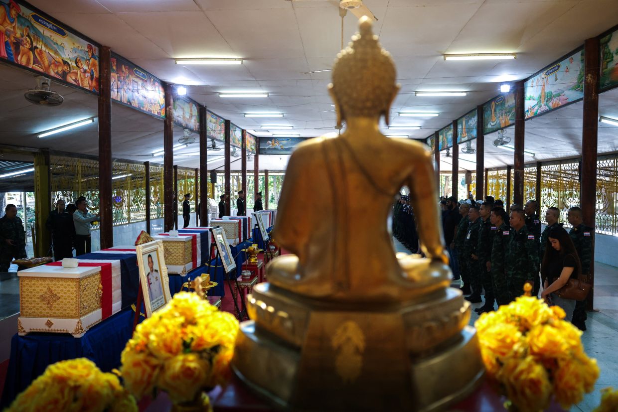 Soldiers, officials and friends of Sergeant Major First Class Damrongkiat Kaewkrachang, Sergeant Major First Class Taweerat Rattanaburi, Private Mustageem Chema and Private Kritdikorn Sroiraya attending a ceremony to transport bodies to their home town, at a hospital, following deadly clashes between Thailand and Cambodia along a disputed border area, in Ubon Ratchathani province, Thailand,on Dec 14, 2025.- Reuters