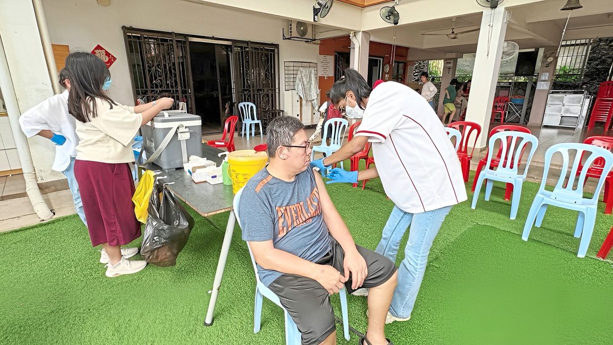 A resident of Rumah Charis in Taman Yarl, Kuala Lumpur, receiving free influenza vaccination offered by Tung Shin Hospital.