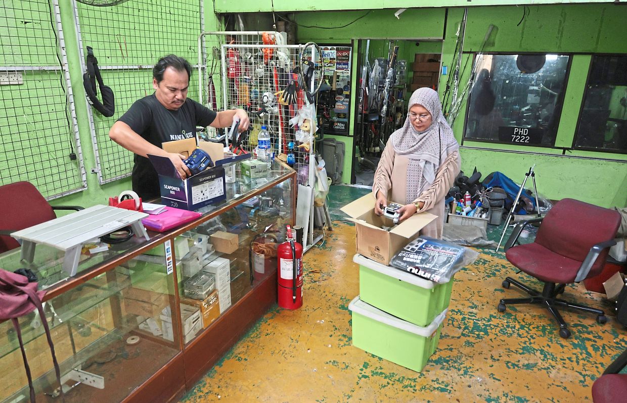 Adam and his wife Sabarina Ahmad Zainol, 50, packing up shop due to a notice to vacate.