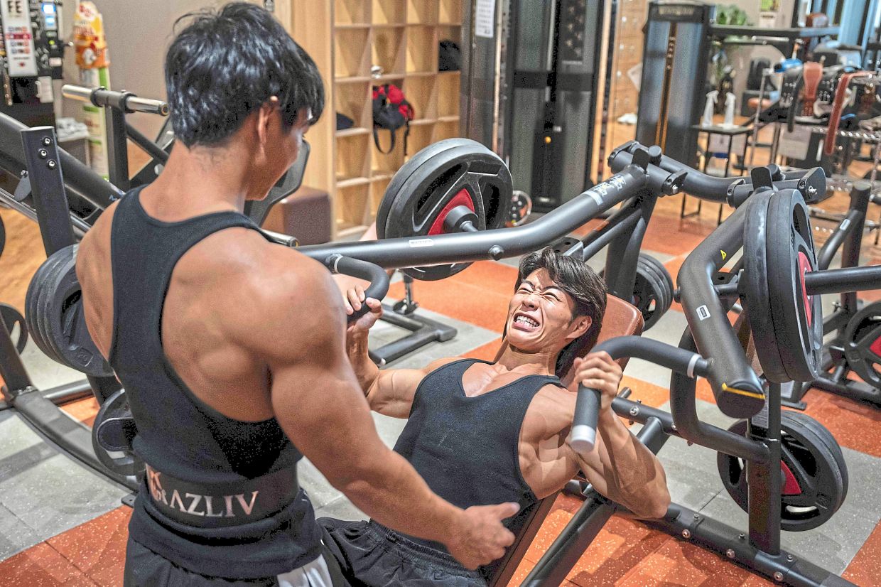 Usui and Tatsumi training at a gym in Ichinomiya. — AFP