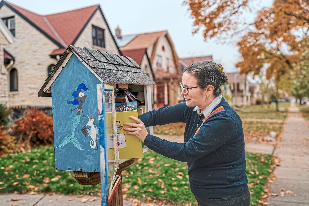 Birken checks the tiny library in front of her home in Wauwatosa, Wisconsin. She and her children maintain it as a community project. Photo: The New York Times/Jamie Kelter Davis