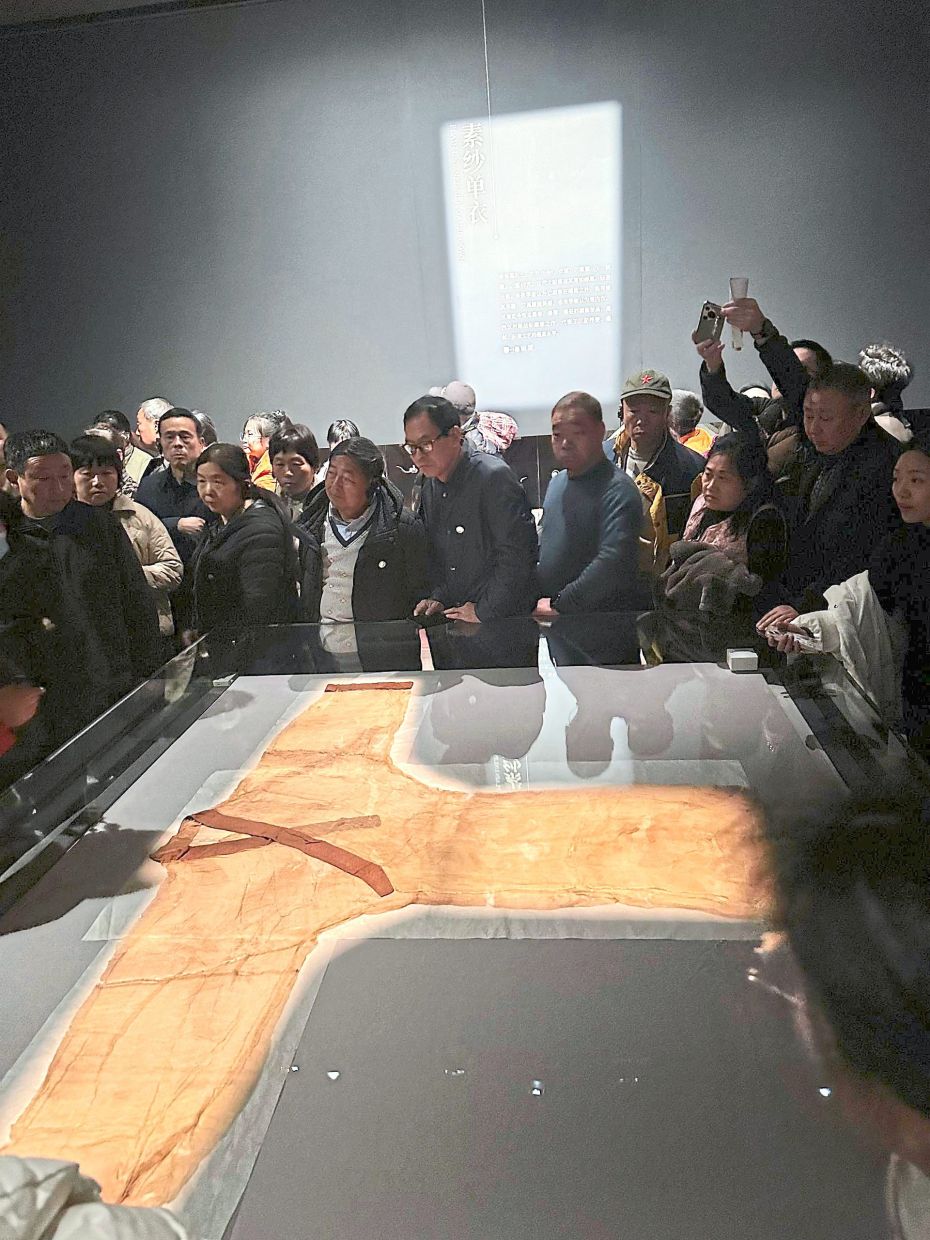 Visitors mesmerised by a 2,000-year-old gauze garment, which weighs only 49g. — PSC