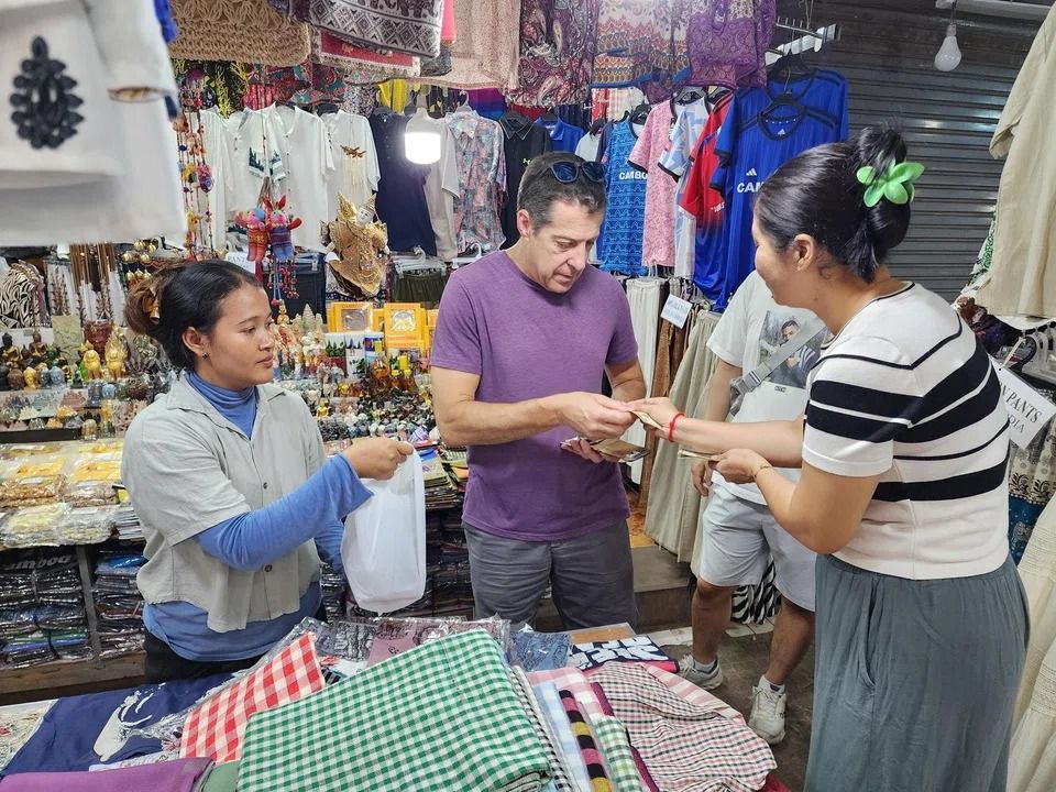 Randy Sundell shopping at Siem Reap's Old Market, which is popular with tourists. - ST/MAY WONG