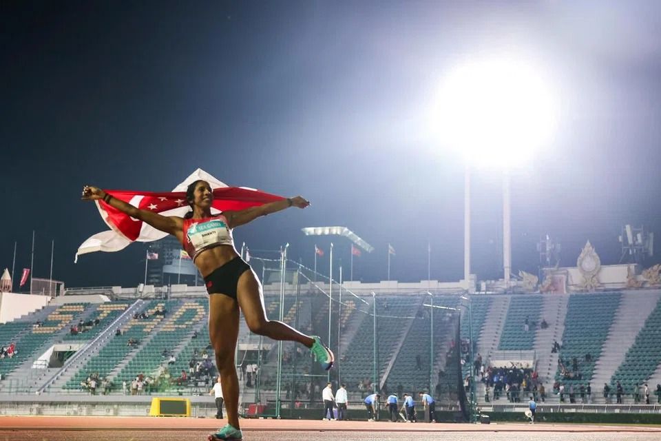 Singapore sprinter Shanti Pereira celebrating after winning the 100m final at the Suphachalasai National Stadium, where few fans were in attendance. -- ST PHOTO: BRIAN TEO