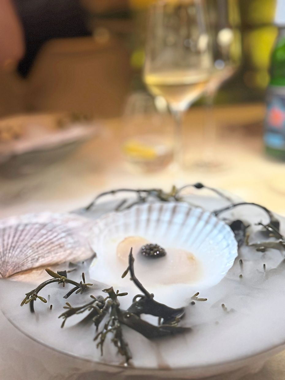 Wisps of smoke add drama to the diver scallops with ‘moules au jus’ and Amur caviar, drizzled with herbaceous oil.