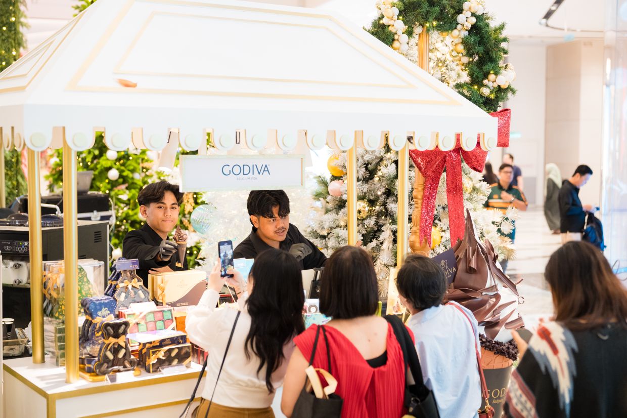 elight in Godiva's chocolate gift sets and creamy soft serve treats at their festive pop-up at the Central Exchange.