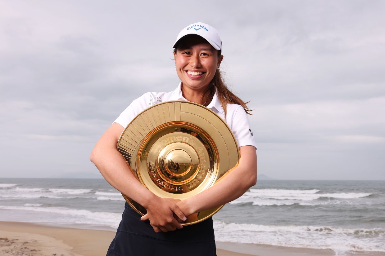 Jeneath Wong of Malaysia poses with the Women's Amateur Asia-Pacific Championship trophy after her victory in 2025. - Photo by Oisin Keniry/R&A/R&A via Getty Images