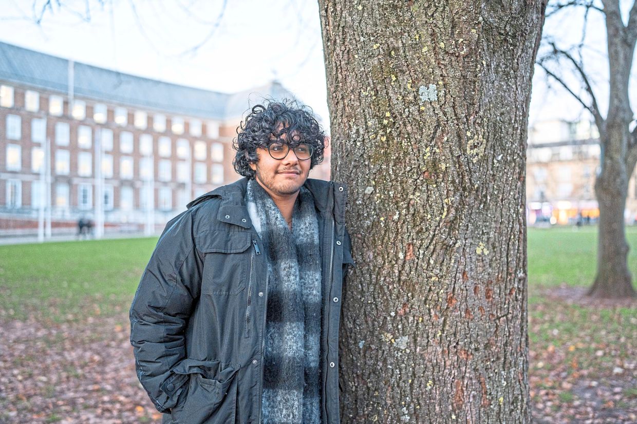 Dhar standing on the grounds of City of Bristol College, in Bristol. — Andrew Testa/The New York Times