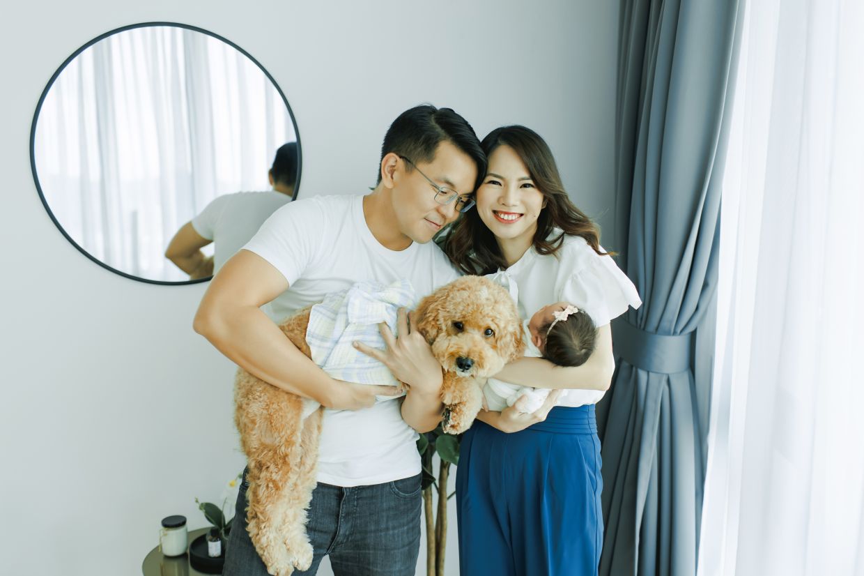 Choo with her husband Ben, their newborn and their dog. The thought of her daughter growing up without a mother has strengthened her resolve to keep fighting cancer.
