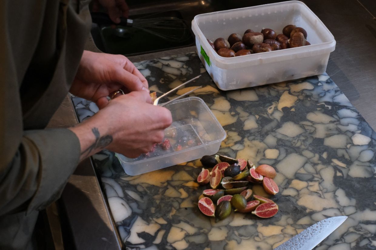 A chef slices figs for a vegan dish at Plates restaurant in London, Britain, November 21, 2025.
