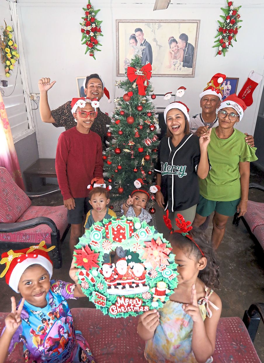Marsh (extreme right) and her family decorate their home for Christmas, undeterred by fears of flooding. 