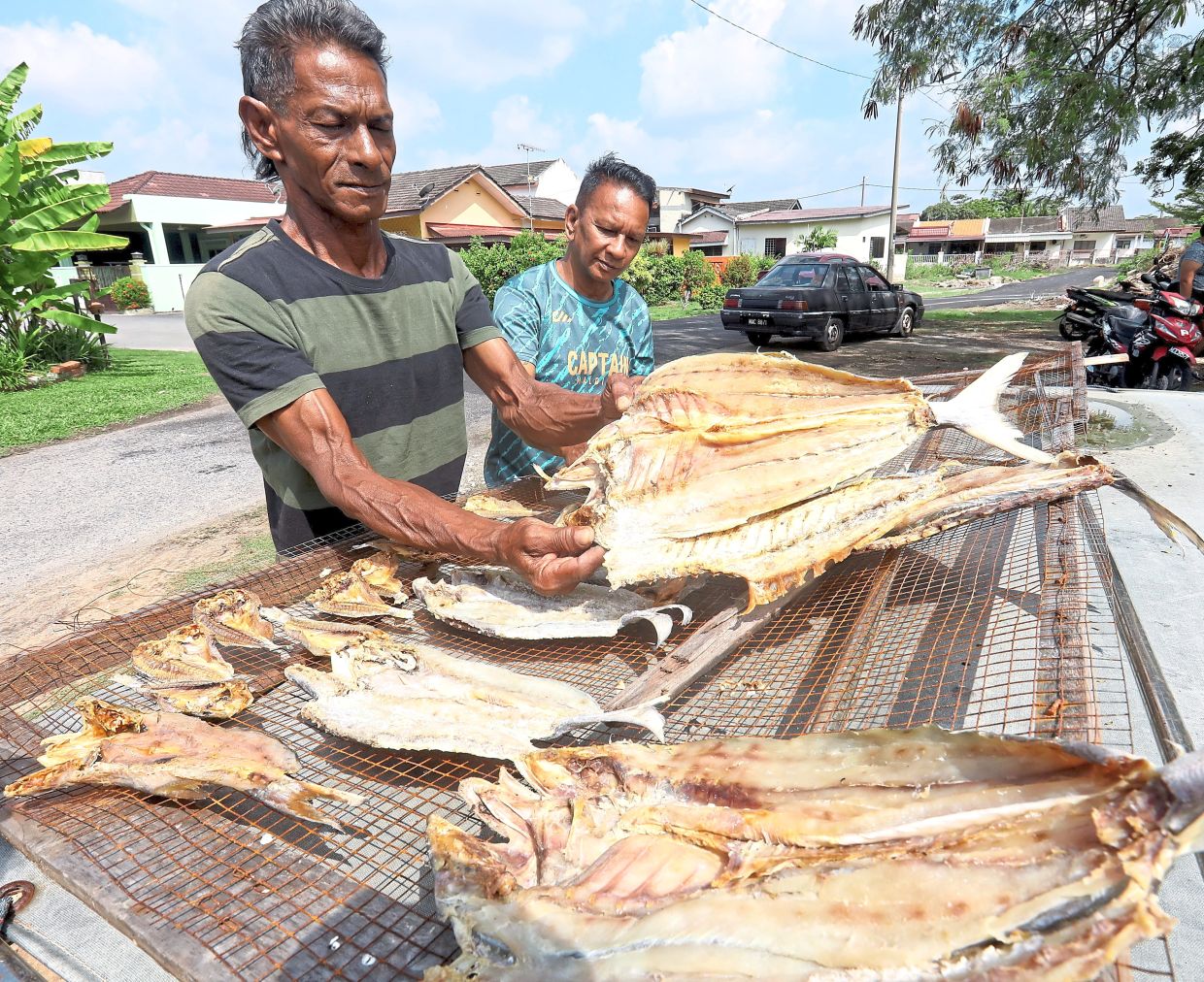DeSilva (right) and his brother-in-law, fisherman Edward Marsh, hope for a better catch in the days ahead.