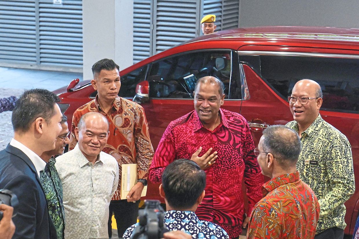 Warm welcome: Ramanan (middle) being greeted by Human Resources Ministry secretary-general Datuk Azman Mohd Yusof (right) as he arrives at Menara PERKESO. — Bernama