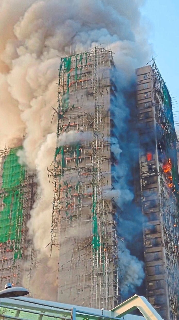Plumes of destruction: Thick clouds of smoke rising as the fire continued to burn at the Wang Fuk Court residential estate. — Bloomberg 