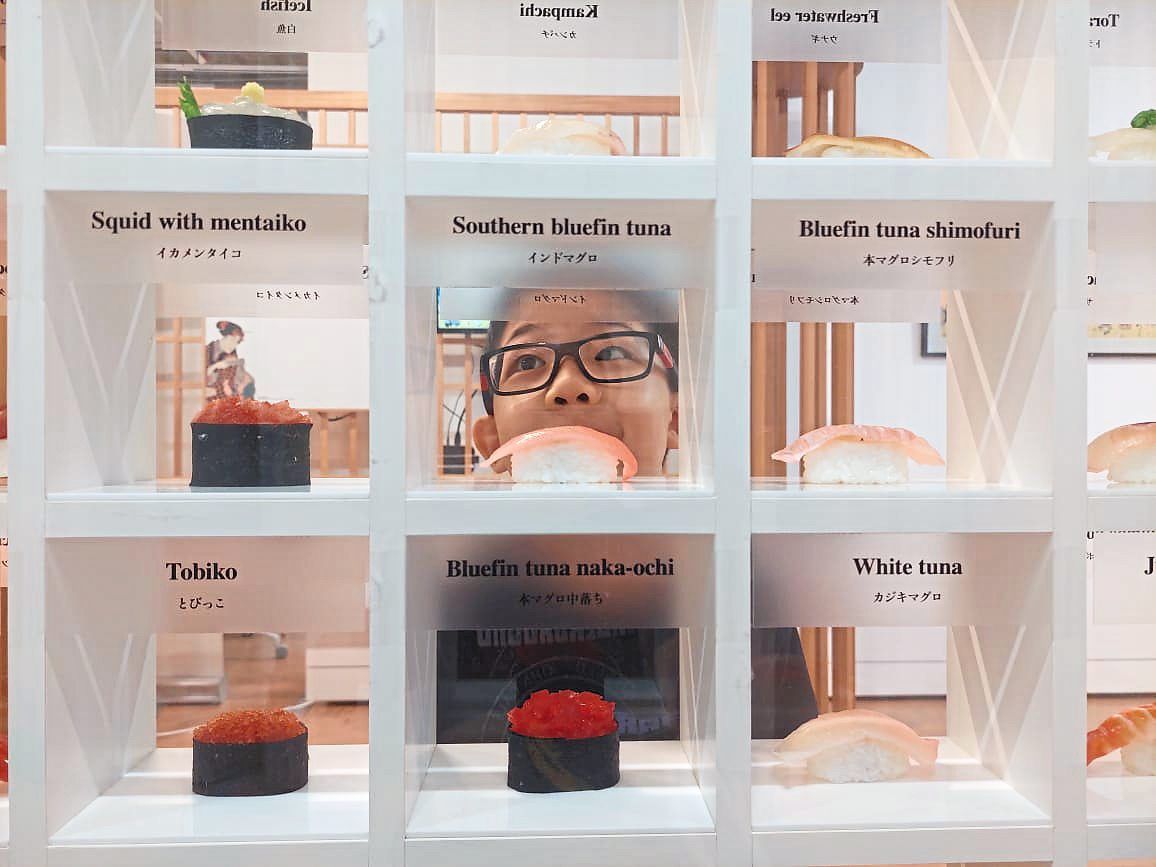 A young visitor peers at a display of different types of sushi at the 'I Love Sushi' exhibition in KL. Photo: The Star/Daryl Goh