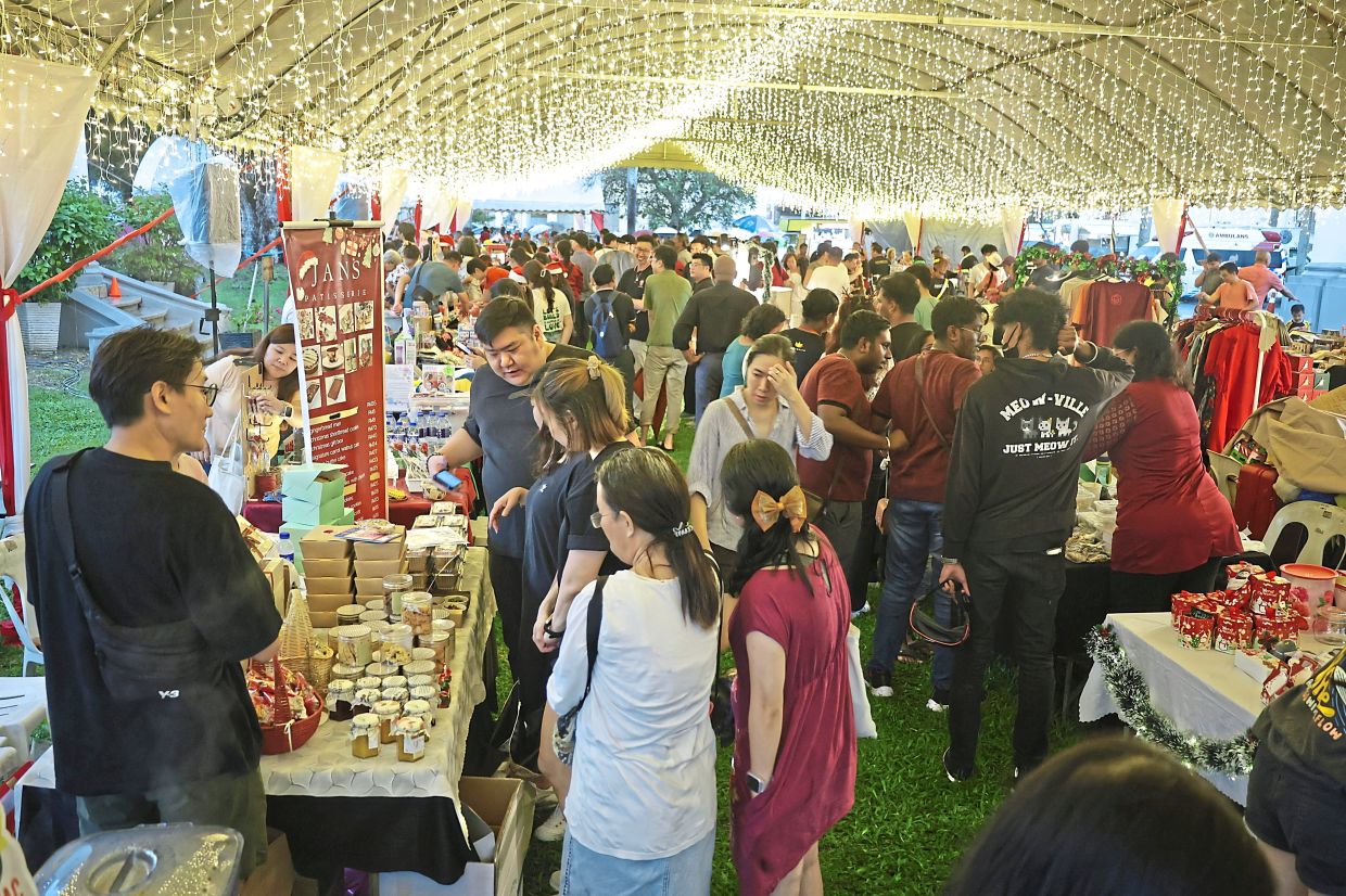 Visitors checking out baked goods, artisanal crafts, toys and gifts on sale at the Christmas market. 