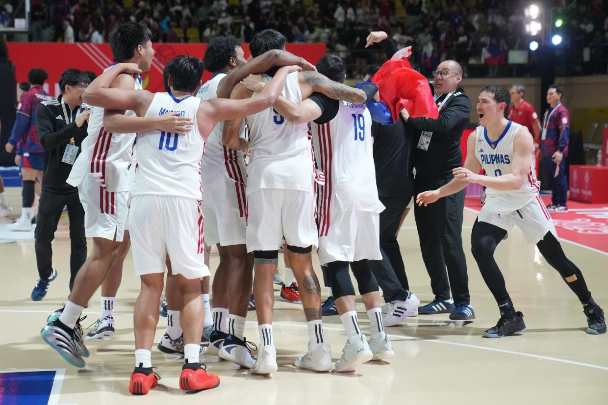 Philippines team palayers celebrate after defeating Thailand's team at their final men's basketball match at the 33rd Southeast Asian Games in Bangkok, Thailand, Friday, Dec. 19, 2025. -- AP Photo/Achmad Ibrahim
