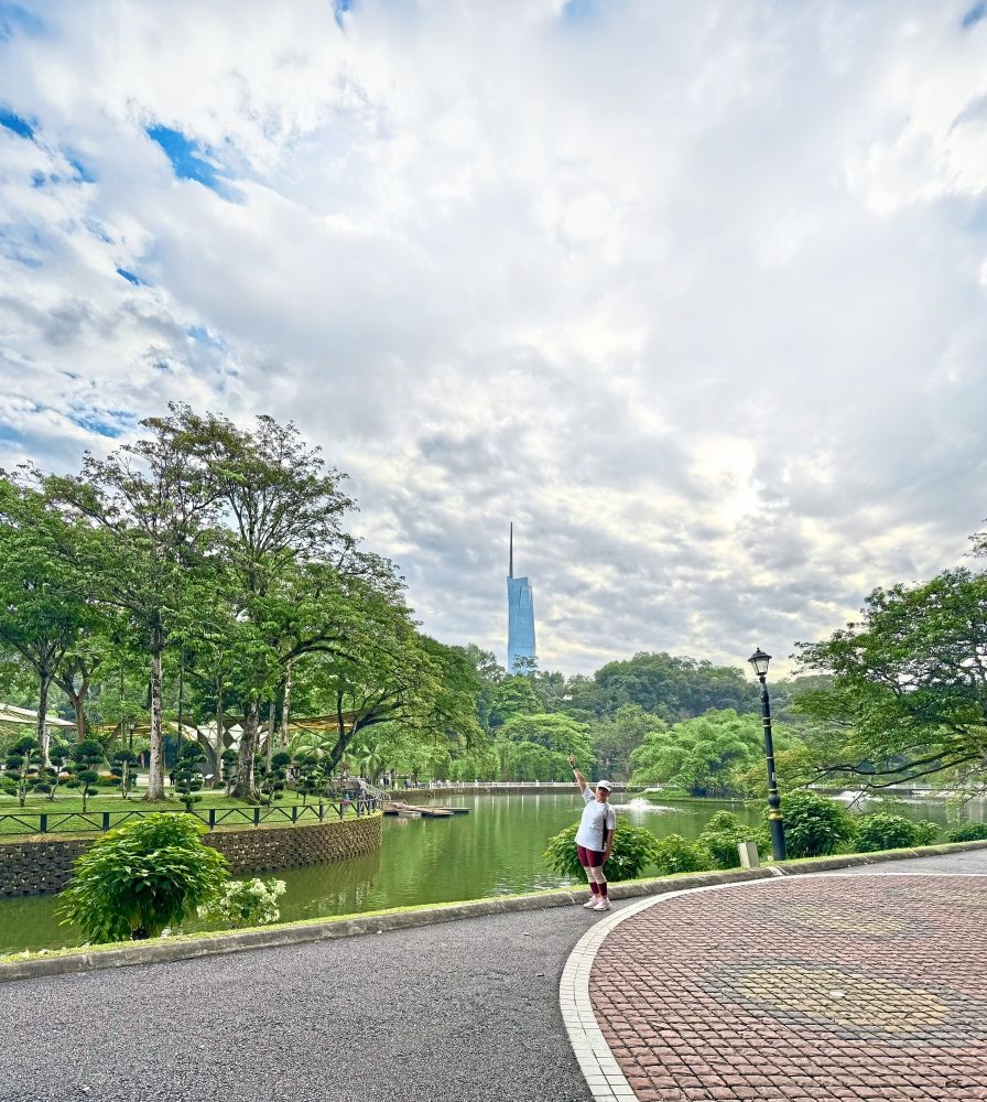 Picturesque stop: A park-goer posing for a photo at Taman Botani Perdana, Kuala Lumpur with Menara Merdeka 118 in the background. — ESTHER CHANDRAN/The Star