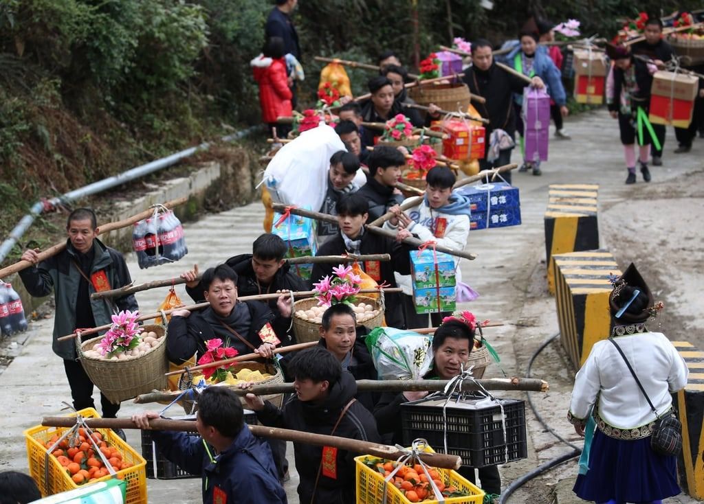 People carry engagement gifts during a ceremonial procession in rural China. - Photo: Getty Images