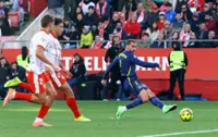 Soccer-In-form Atletico ease to 3-0 victory at lowly Girona