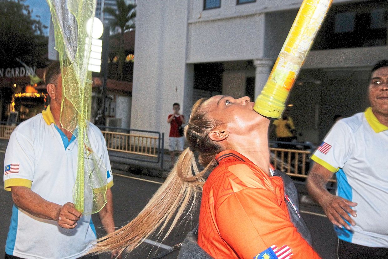 Noorfadzilah executing a stunt during the parade. — LIM BENG TATT/The Star