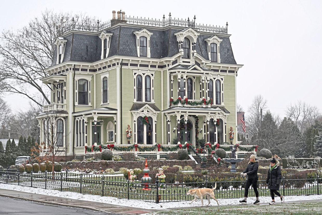 People walking by the Silas W Robbins bed-and-breakfast in Wethersfield, Connecticut, where parts of Christmas On Honeysuckle Lane were filmed. — Photos: AP