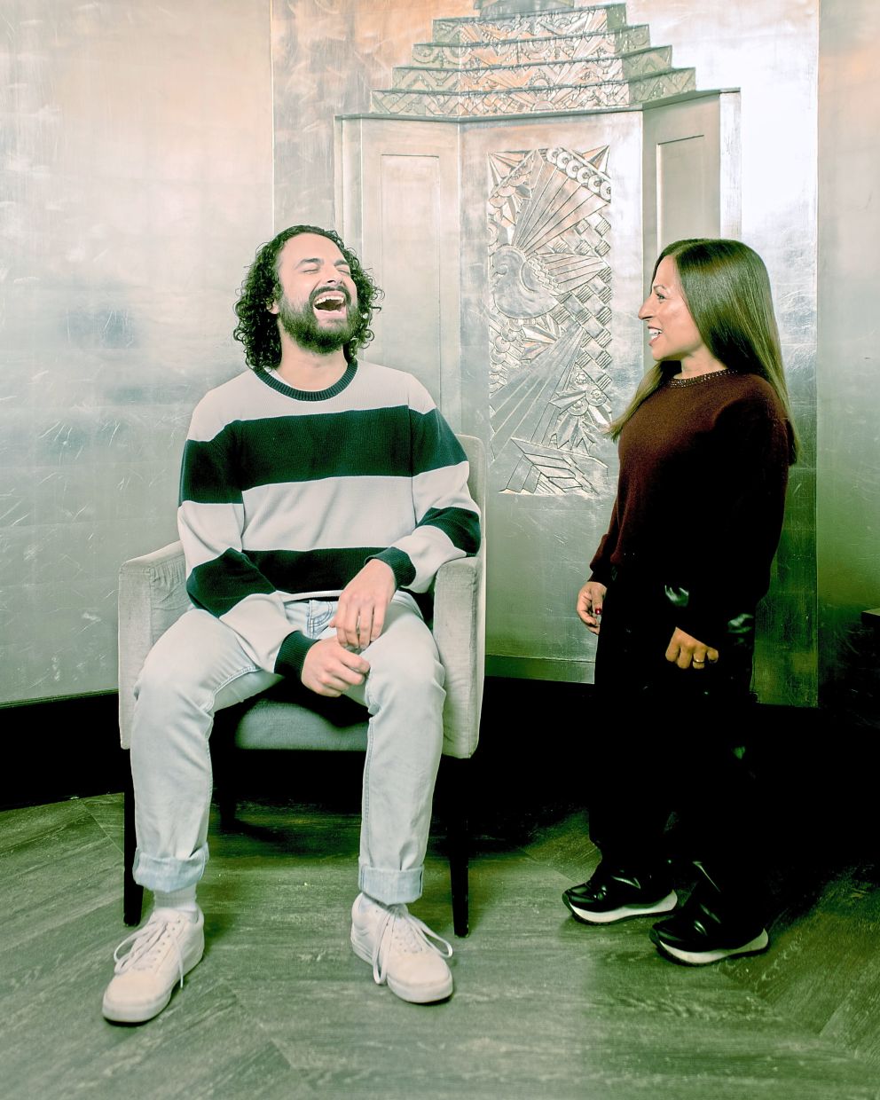 James Hameed (left), who voices Paddington offstage and controls his facial movements, and Arti Shah, who plays Paddington in a suit, in 'Paddington: The Musical'.