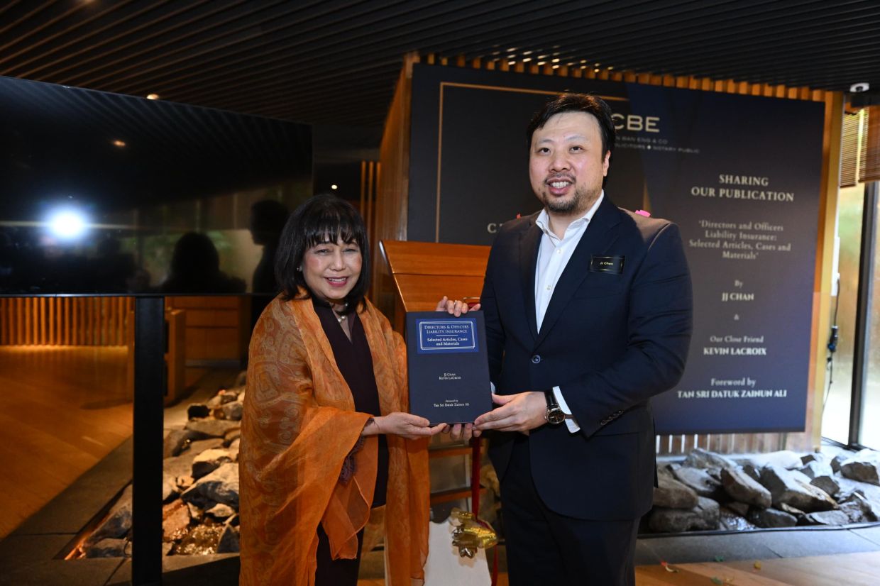 Chan (right) presenting Tan Sri Zainun Ali (left) with a special edition of the book featuring a foreword by the latter on Dec 19.