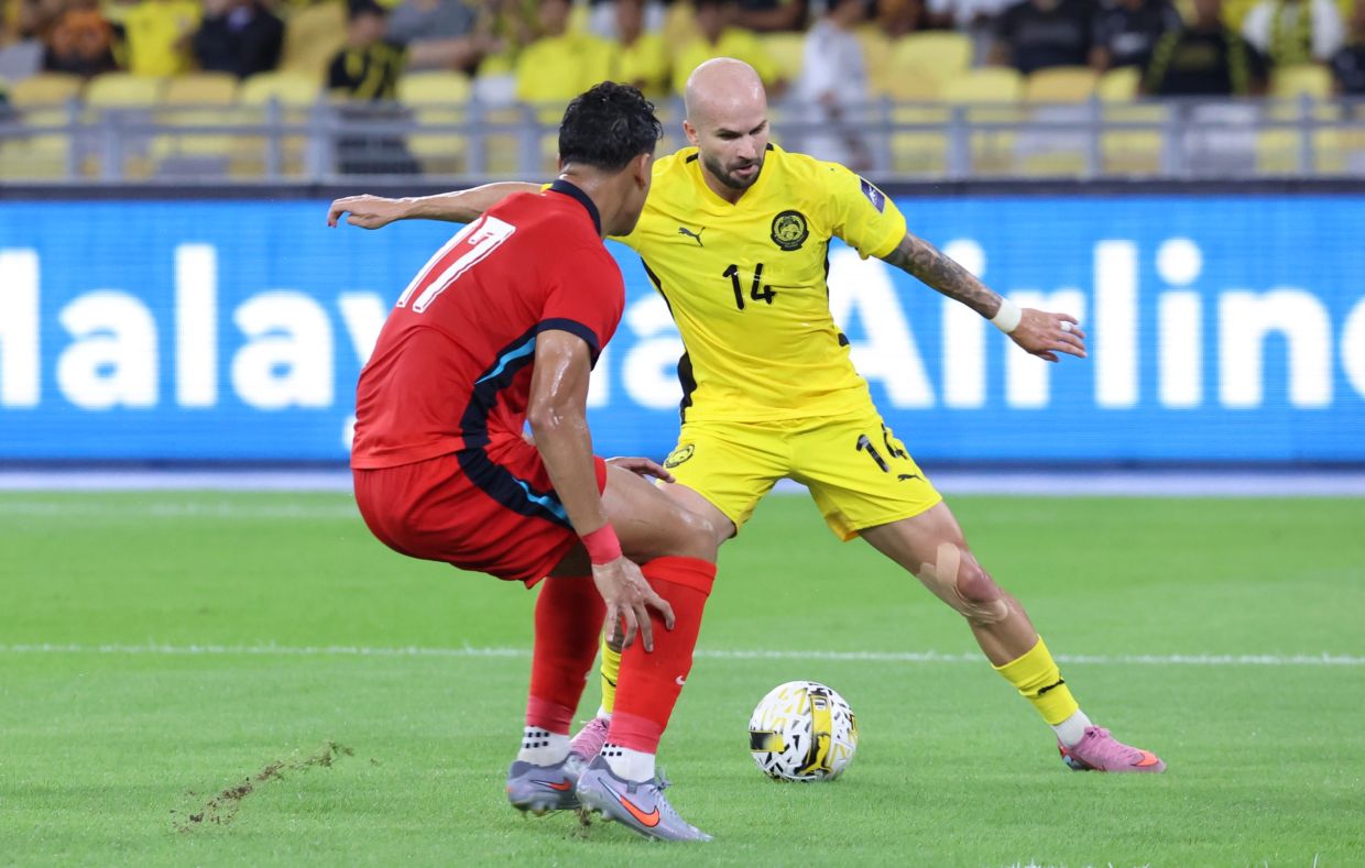 Good times: Malaysia’s Joao Figueiredo (right) fighting for the ball with Singapore’s Irfan Fandi Ahmad (left) during the international friendly match at the National Stadium in Bukit Jalil, Kuala Lumpur.— MUHAMAD SHAHRIL ROSLI/The Star