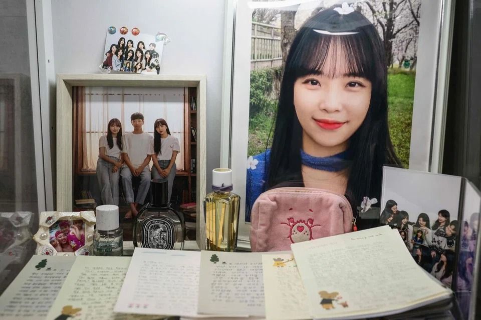Family photos and letters written in memory of cello instructor Ye-won (right) at her family home in Gwangju. - Photo: AFP