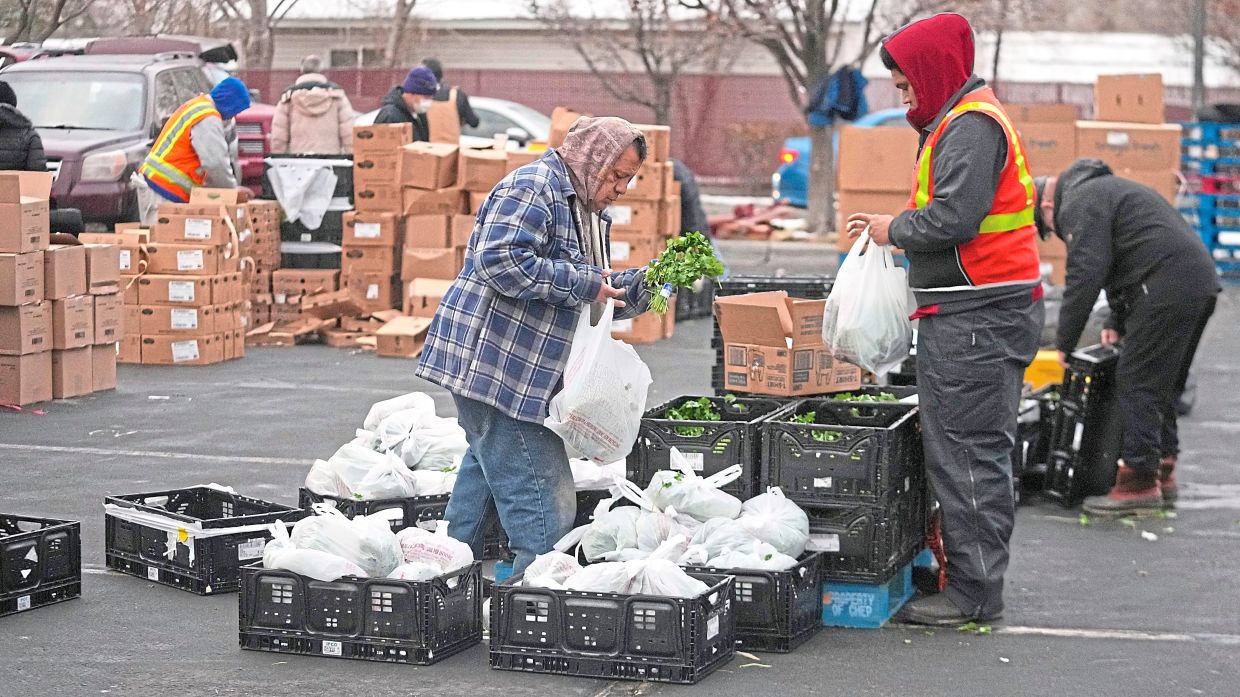 A file photo of Utah Food Bank volunteers gathering groceries for the needy at a mobile food pantry distribution site in December 2022 in Salt Lake City.