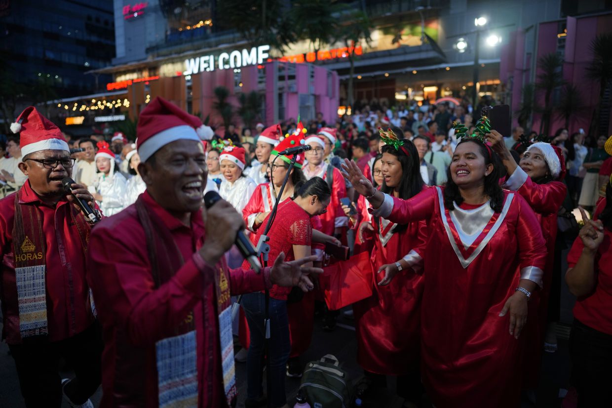 People singing Christmas carols in Jakarta on Dec 23, 2025. - AP