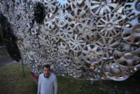 Recycling cyclist: US cyclist collects lost hubcaps and turns them into art