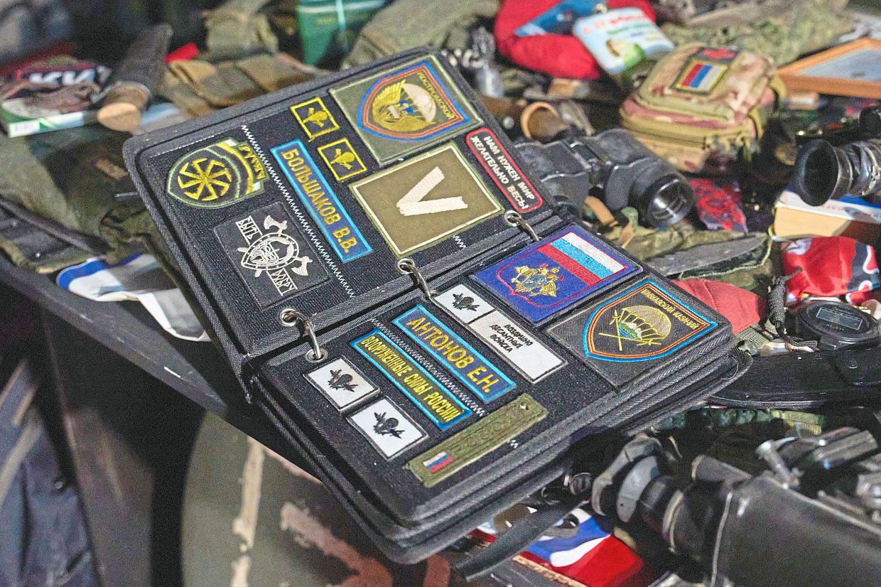 A Russian officer's bag with military patches is one of the exhibits. 