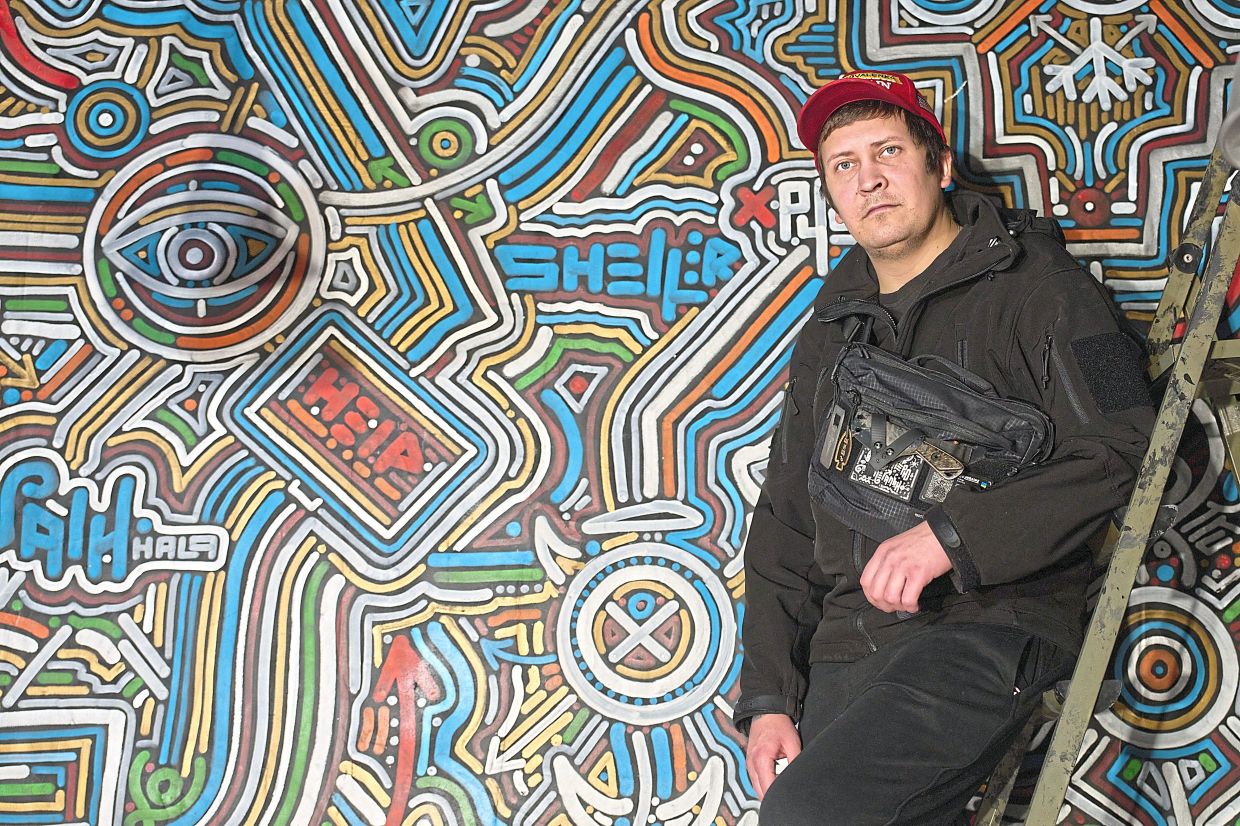 Kilderov stands by his painting containing symbols and messages of resistance in his private museum.