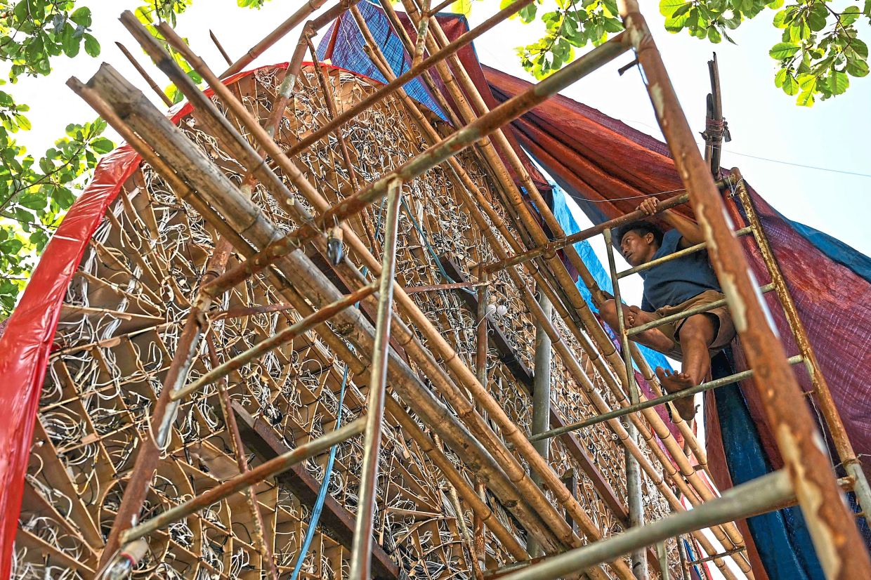 With bamboo and metal scaffolding, craftsmen build the lanterns bit by bit, bringing them to life for the festival of lights.