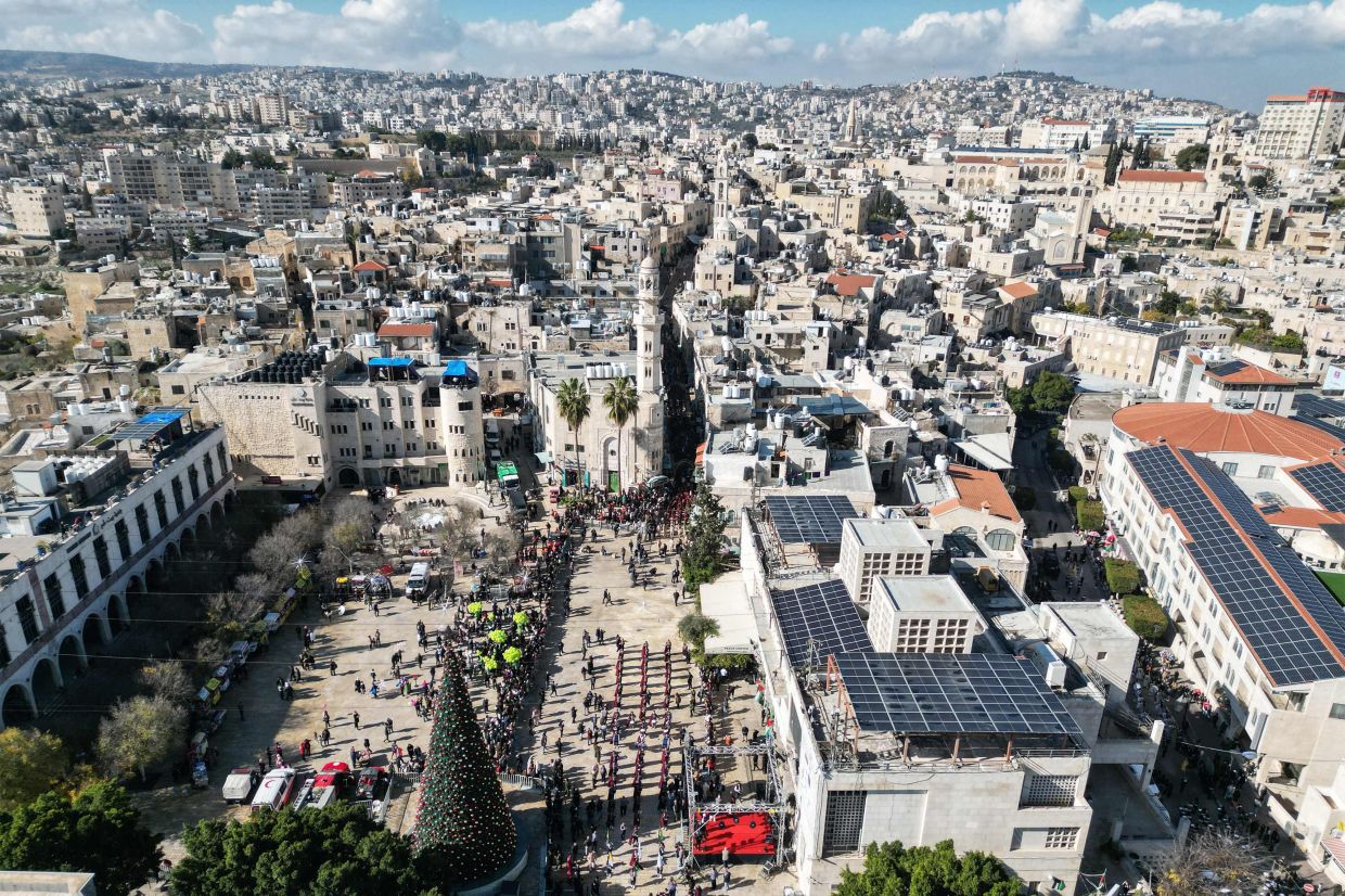 An aerial view shows scouts marching during Christmas eve celebrations on Manger Square outside the Church of the Nativity (unseen) in Bethlehem, in the Israeli-occupied West Bank. Photo: AFP