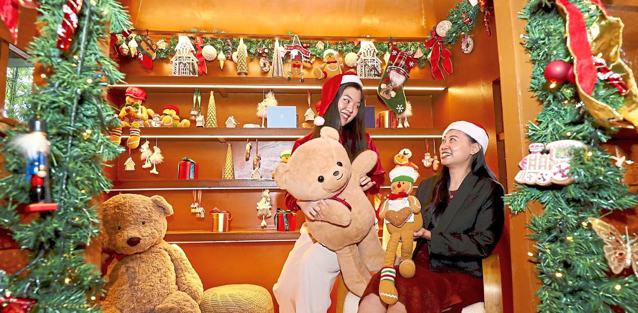 Good cheer: Maxine Lim (right) and Grace Chan enjoying the festive spirit at the Hyatt Regency in Kuala Lumpur. — LEONG WAI YEE/The Star