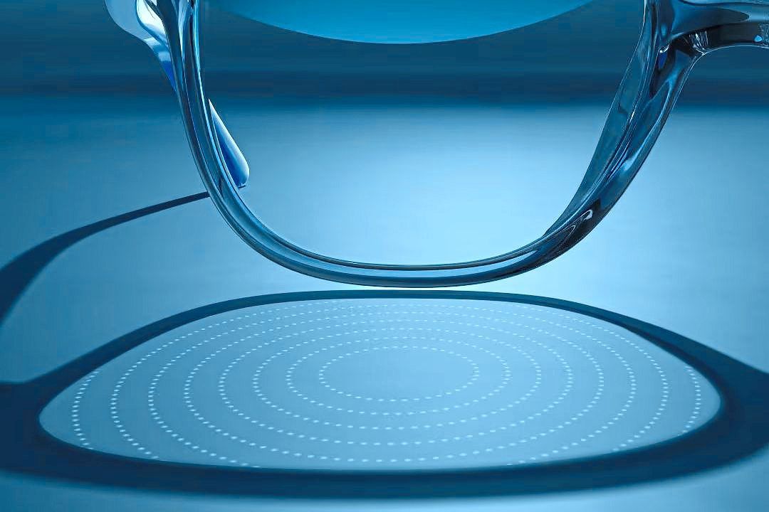 Refractions caused by lenslets embedded in the eyeglass lens are projected onto a table. Photo: Luxottica via AP
