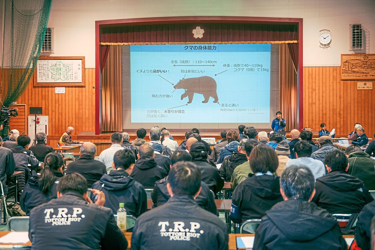 Local officials, police and hunters at a bear safety workshop in the mountainous town of Chizu, Tottori prefecture. — Kentaro Takahashi/The New York Times